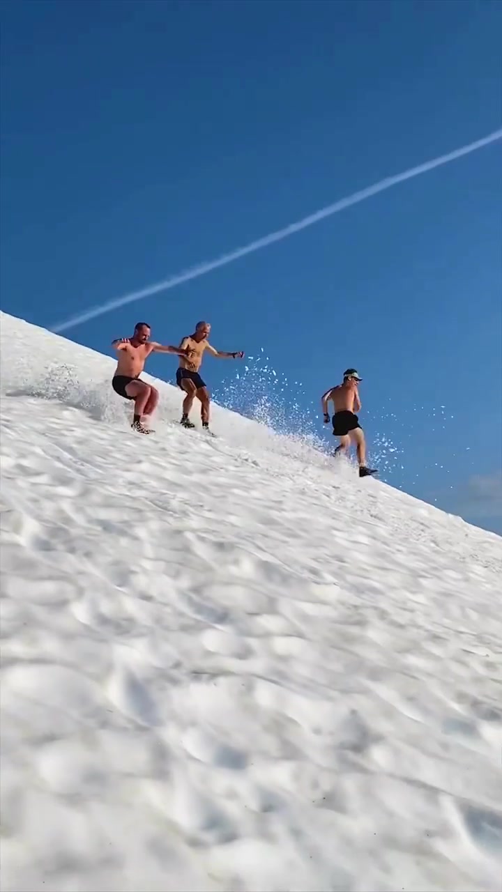 Men Running Down Snowy Slope at Alyeska Resort
