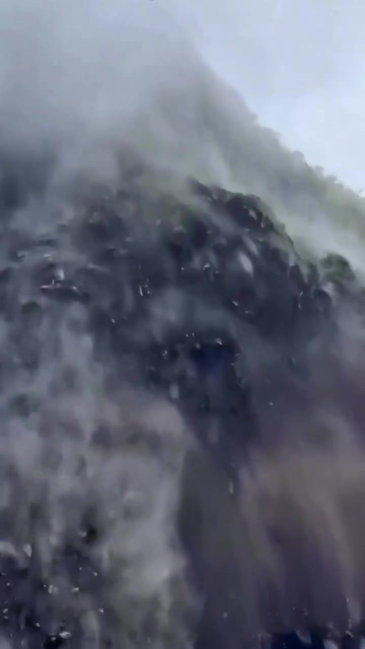 Mountainside Waterfall: Dramatic Misty View