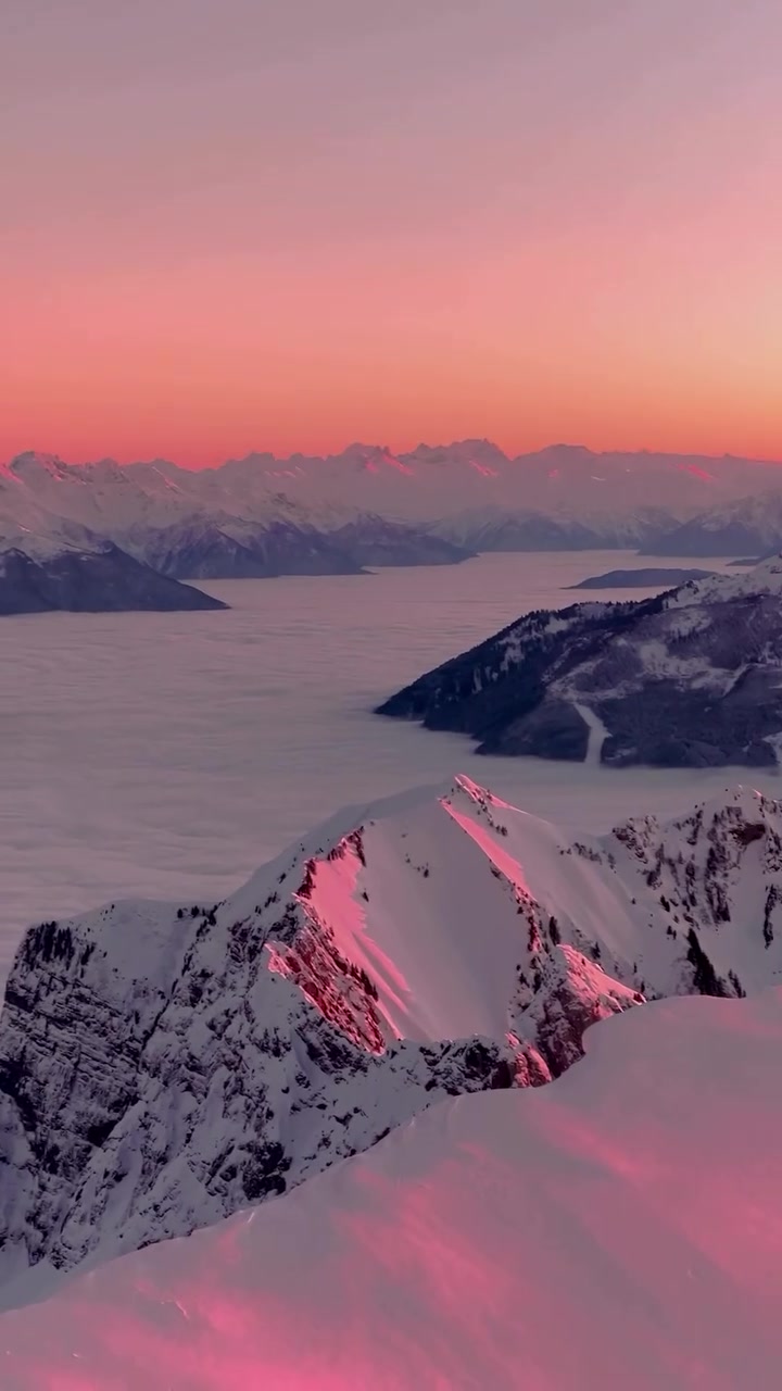 Mountain Sunrise: Aerial View of Snow-Capped Peaks