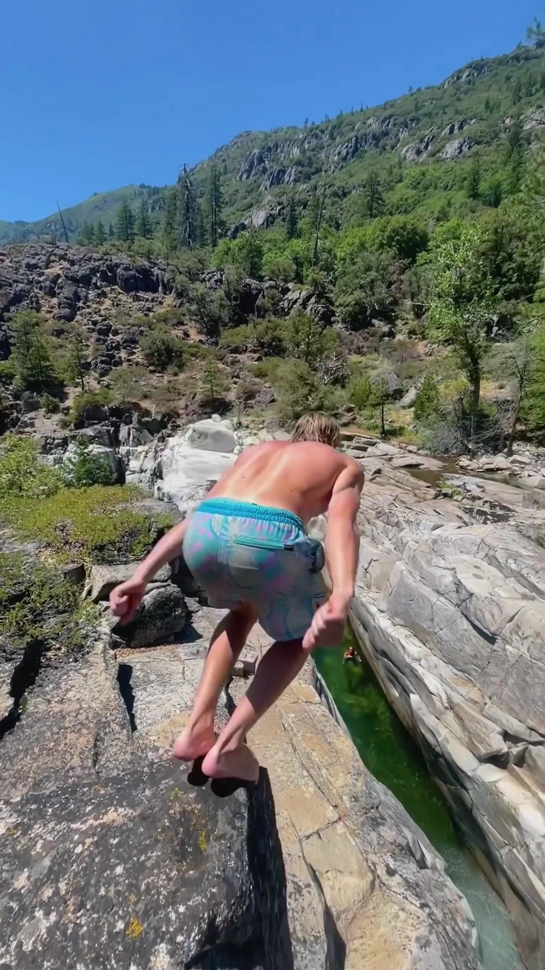 Outdoor Adventure: River Jump in Rocky Terrain