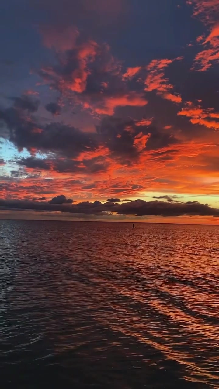 Sunset Over Water: Dramatic Sky and Reflection