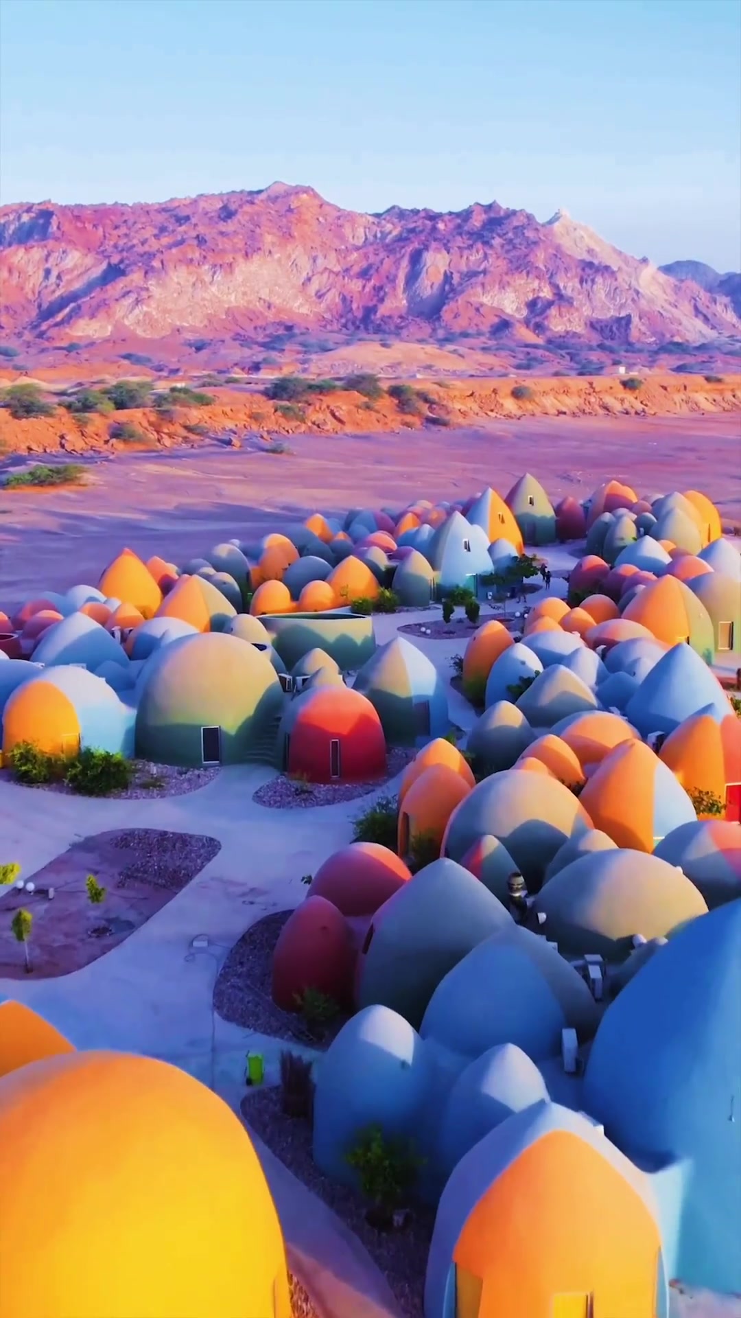 Desert Architecture: Vibrant Domes in Reddish Landscape
