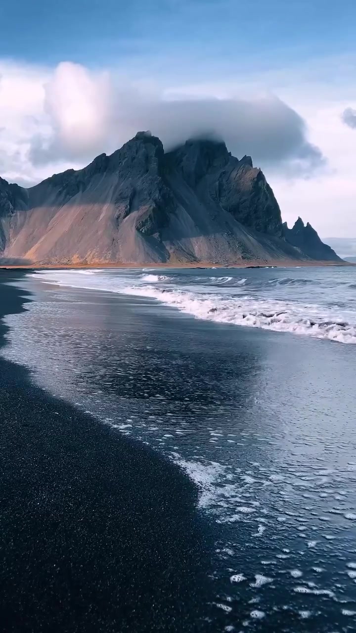 Black Sand Beach with Mountain Backdrop