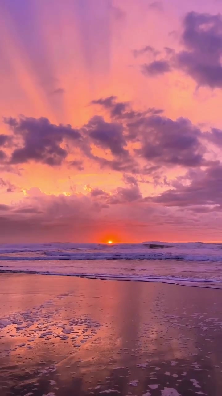 Sunset Surfers: Ocean Waves at Dusk