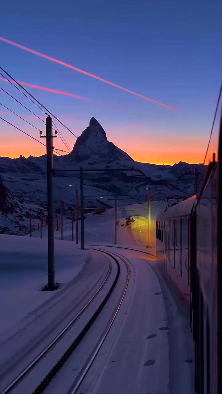 Scenic Train Ride Through Snowy Mountains