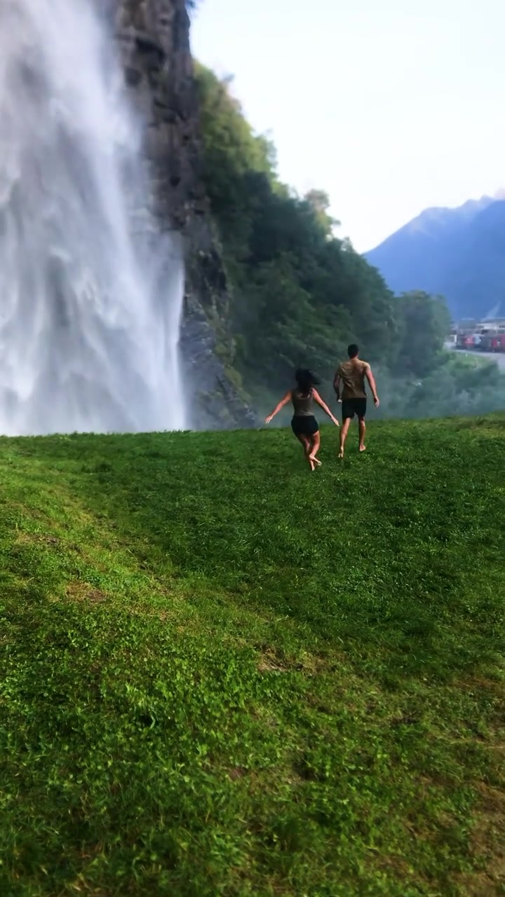 Couple Running Towards Waterfall Adventure