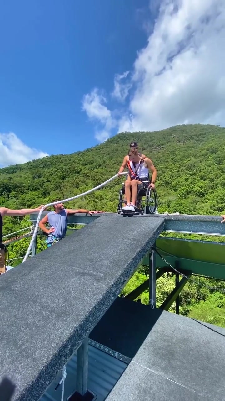 Man in Wheelchair Enjoying Tropical Bridge View