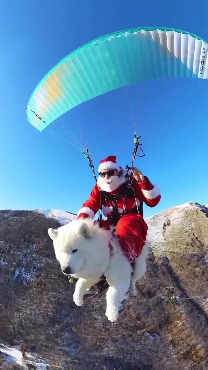 Santa Claus Paragliding with Dog Over Snowy Hills