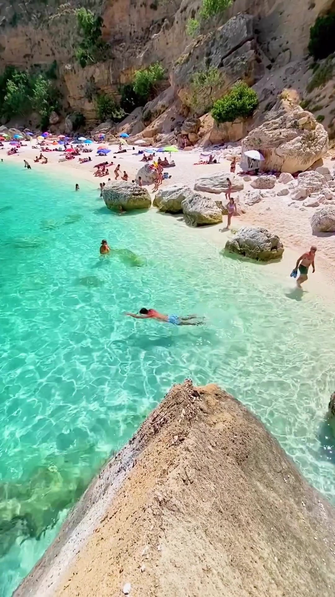 Beach Scene: Clear Water and Rocky Cliffs