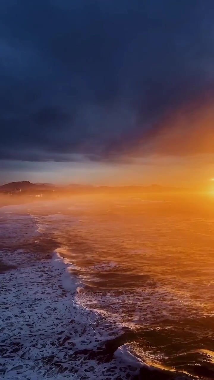 Ocean Sunset: Waves and Warm Orange Light