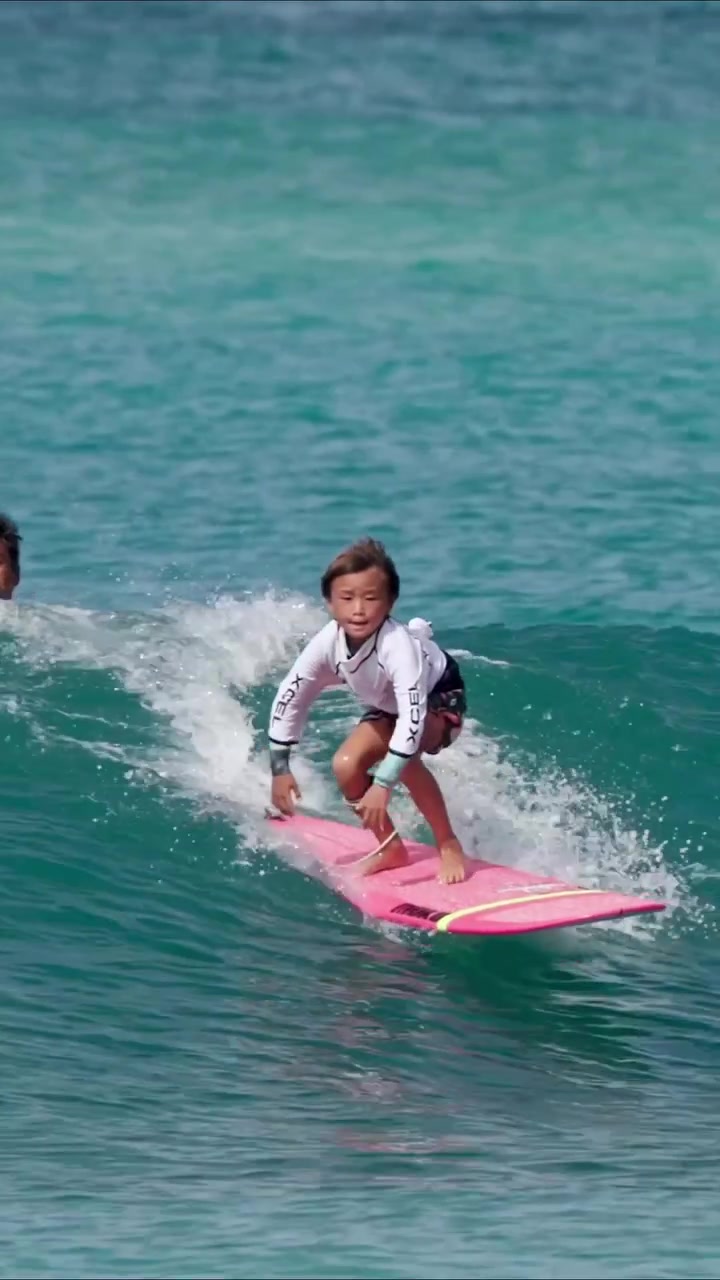 Young Boy's First Surfing Lesson with Instructor