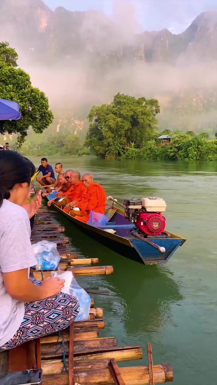 Buddhist Monks' River Boat Ride in Tropical Landscape