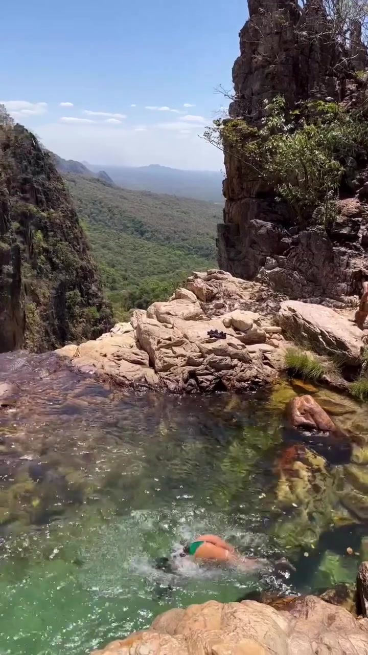 Swimming in a Scenic Waterfall Pool