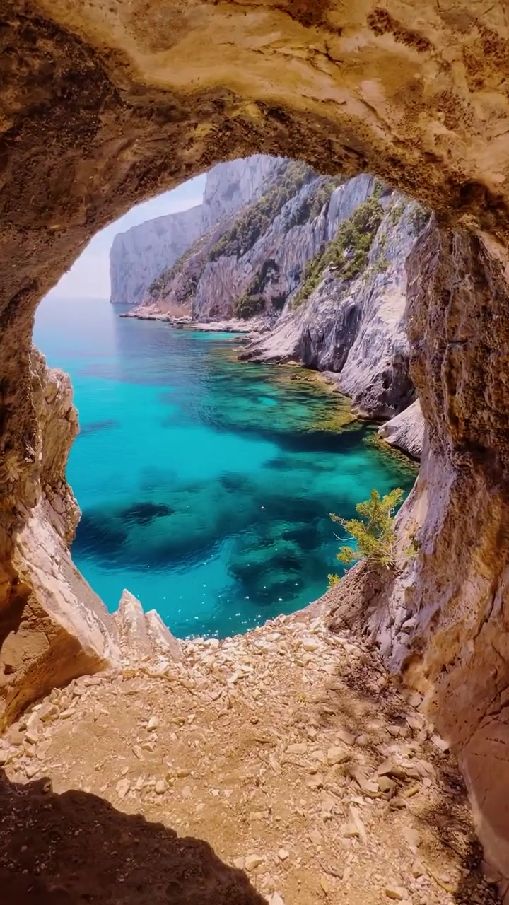 Cave View: Turquoise Bay and Rugged Coastline