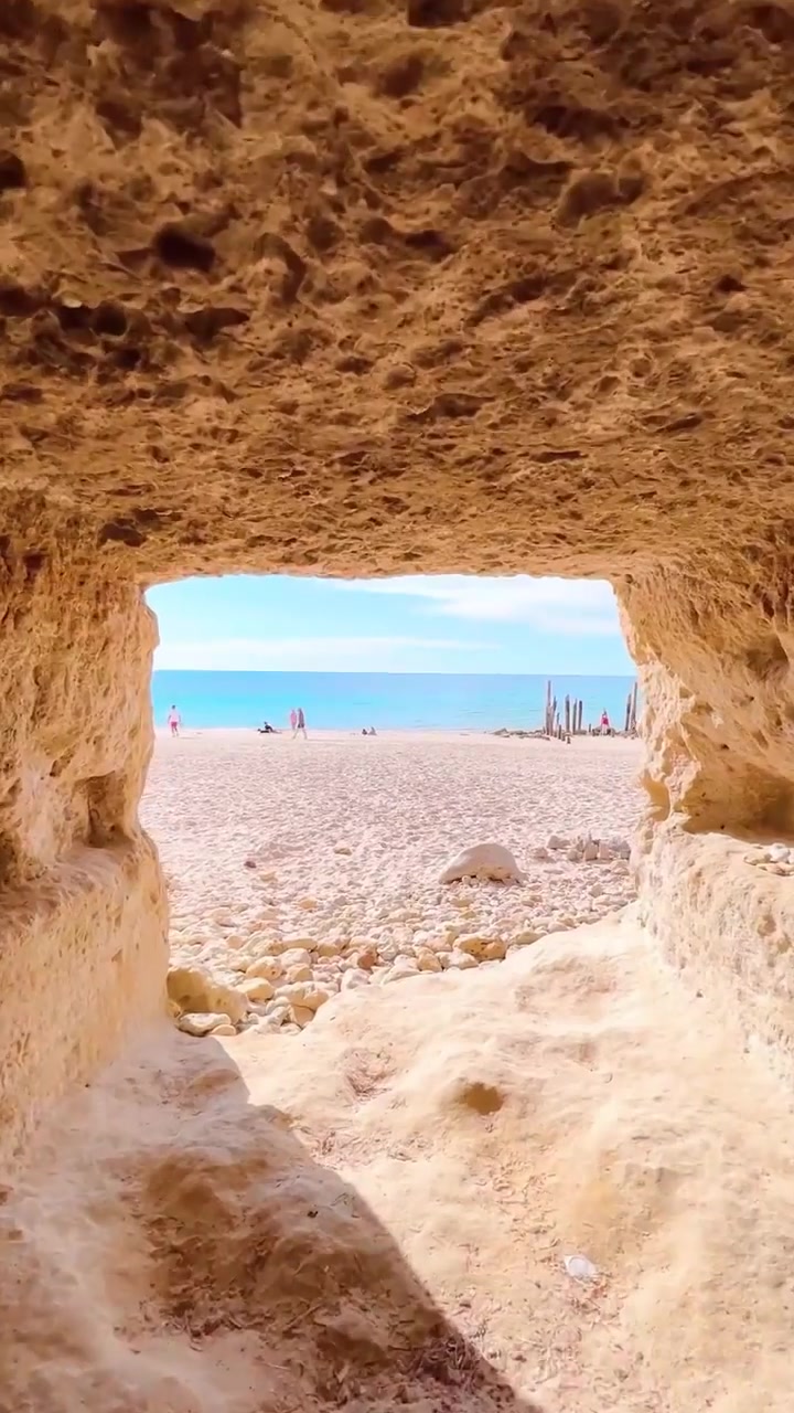 Beach View Through Rock Arch: A Scenic Paradise