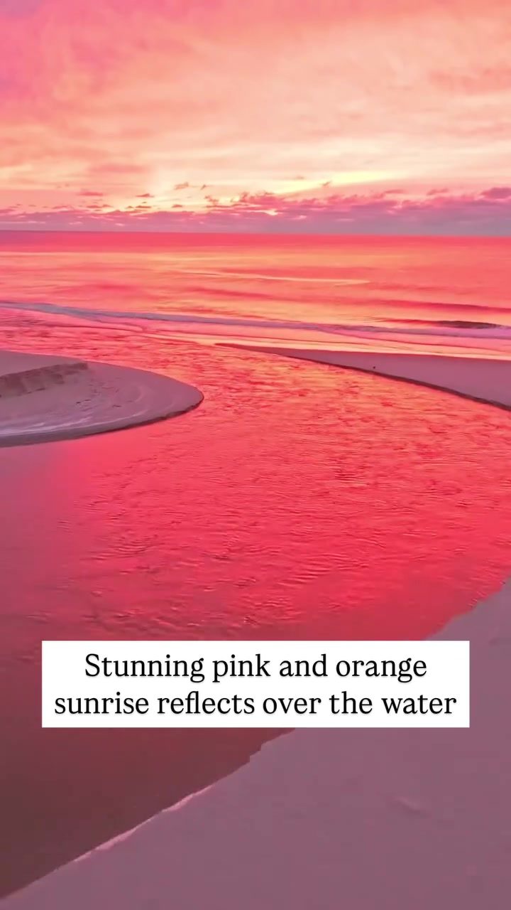 Witnessing a Vibrant Sunrise Reflection Over Water