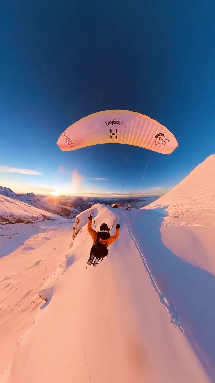 Paragliding Over Snowy Mountains: Aerial Sunrise Flight