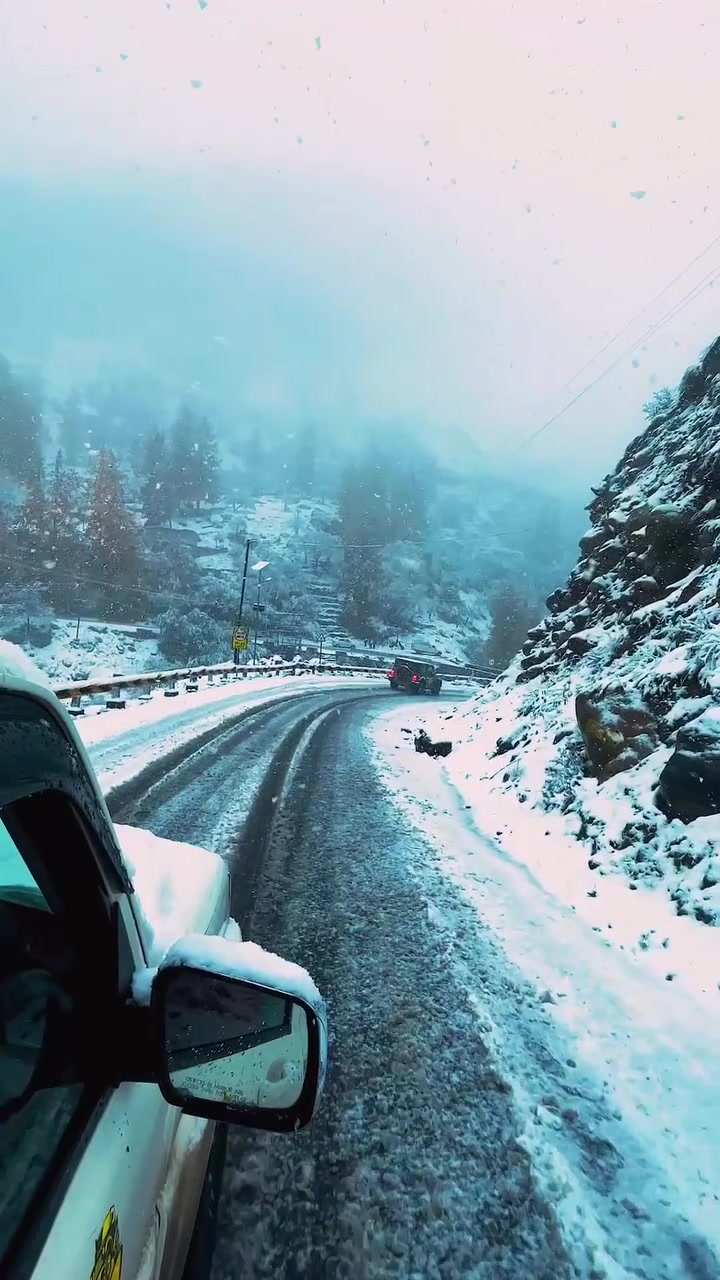 Driving a Snowy Mountain Road in a Car