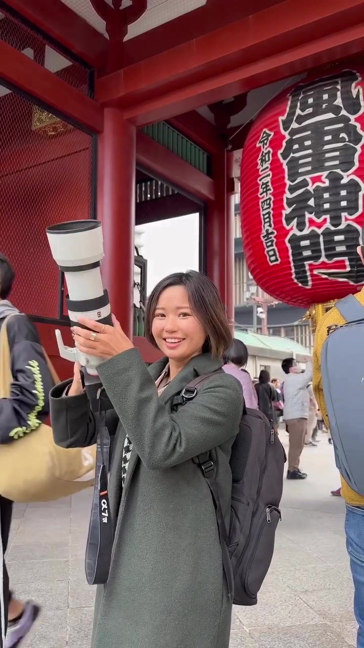 Tourist Photographing Cherry Blossoms at Japanese Temple
